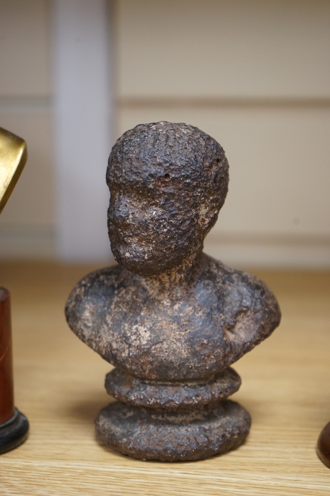 A bronze bust of Napoleon, a bust of Ajax and a cast iron bust of an Emperor, tallest 18cm